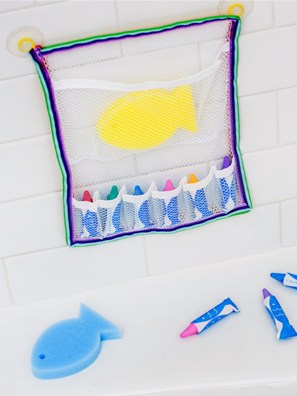 Crayons for painting in a bathtub with an organizer and a sponge