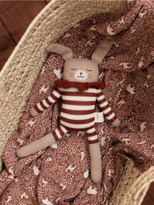 a large cuddly toy made of alpaca bunny sienna striped romper