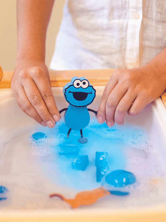 Sensory cubes glowing in water with a Sesame Street figure