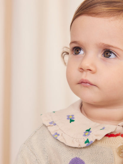 Baby camicetta con fiori di viola del pensiero su tutta la superficie